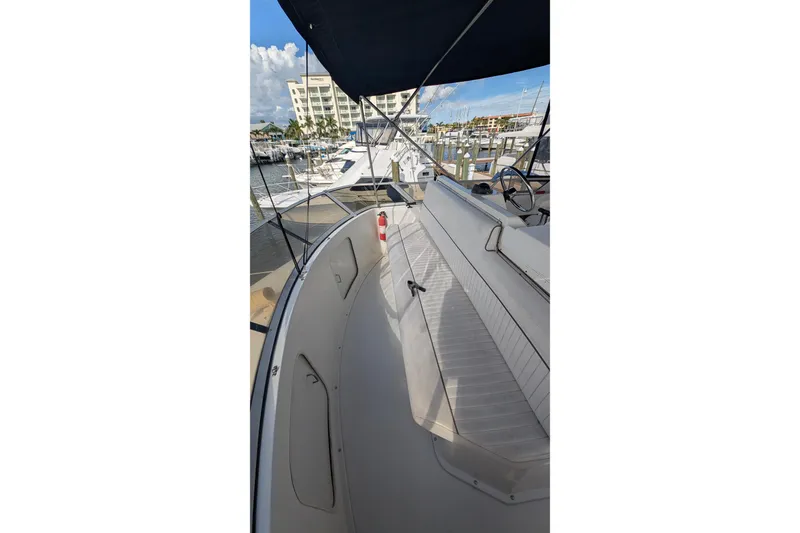 Slide: The Image of 1994 Carver 370 Aft Cabin Motor Yacht docked at marina, featuring spacious deck area. - 12