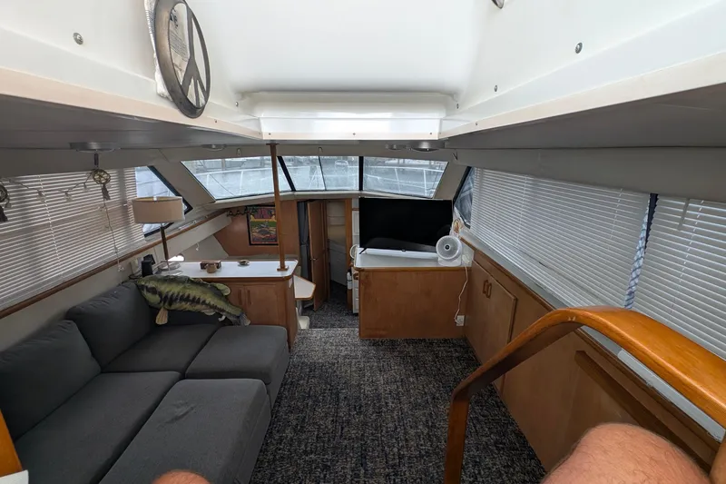 Slide: The Image of Interior of 1994 Carver 370 Aft Cabin Motor Yacht with cozy seating and decor. - 21