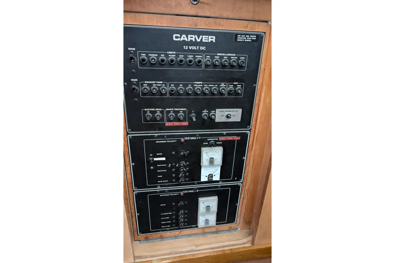 Slide: The Image of Control panel of 1994 Carver 370 Aft Cabin Motor Yacht, featuring switches and gauges. - 26