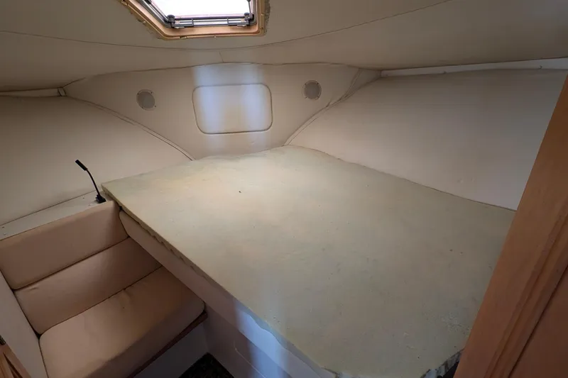 Slide: The Image of Interior cabin of 1994 Carver 370 Aft Cabin Motor Yacht, featuring a bed and seating area. - 36