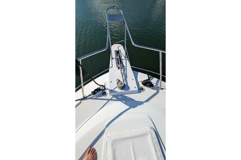 Slide: The Image of Bow view of 1994 Carver 370 Aft Cabin Motor Yacht on water. - 4