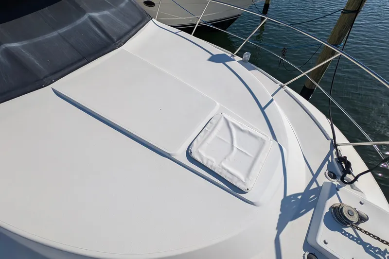 Slide: The Image of 1994 Carver 370 Aft Cabin Motor Yacht deck with railing and hatch, docked on water. - 6