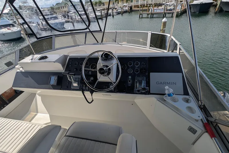 Slide: The Image of 1994 Carver 370 Aft Cabin Motor Yacht helm with Garmin navigation, docked at marina. - 7
