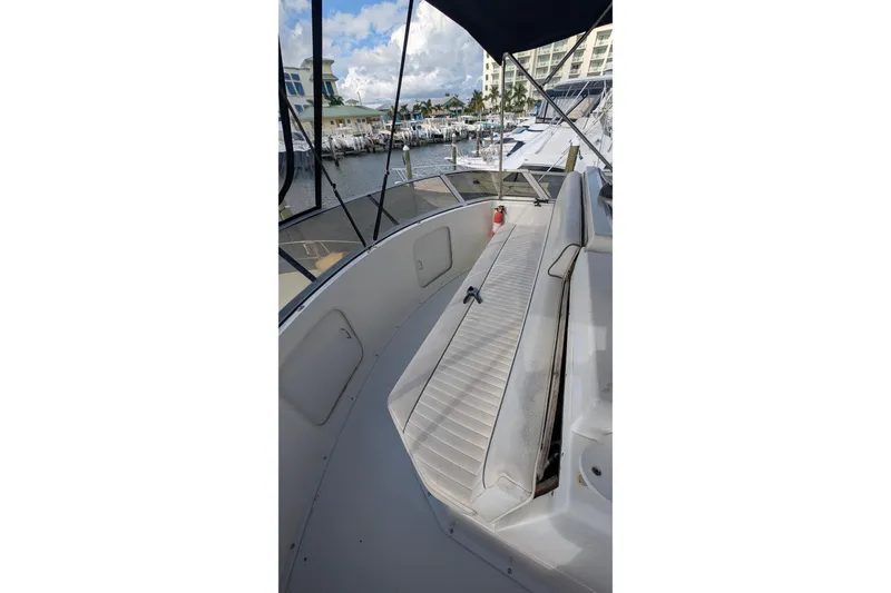 Slide: The Image of 1994 Carver 370 Aft Cabin Motor Yacht deck with seating, docked at marina. - 11