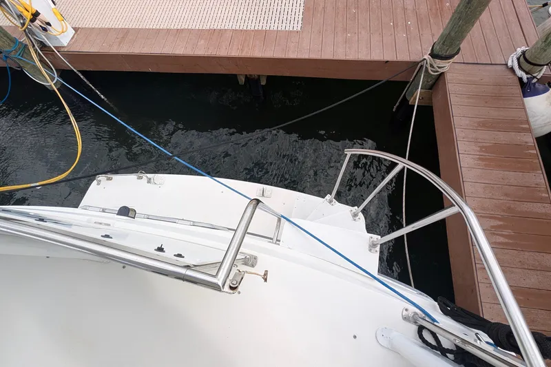 Slide: The Image of 1994 Carver 370 Aft Cabin Motor Yacht docked, showing rear deck and railing. - 16