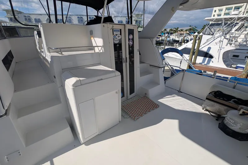 Slide: The Image of 1994 Carver 370 Aft Cabin Motor Yacht interior with seating and marina view. - 17