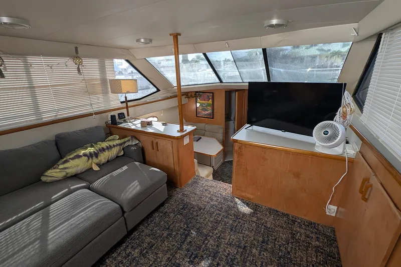 Slide: The Image of Interior of 1994 Carver 370 Aft Cabin Motor Yacht with sofa, TV, and windows. - 22