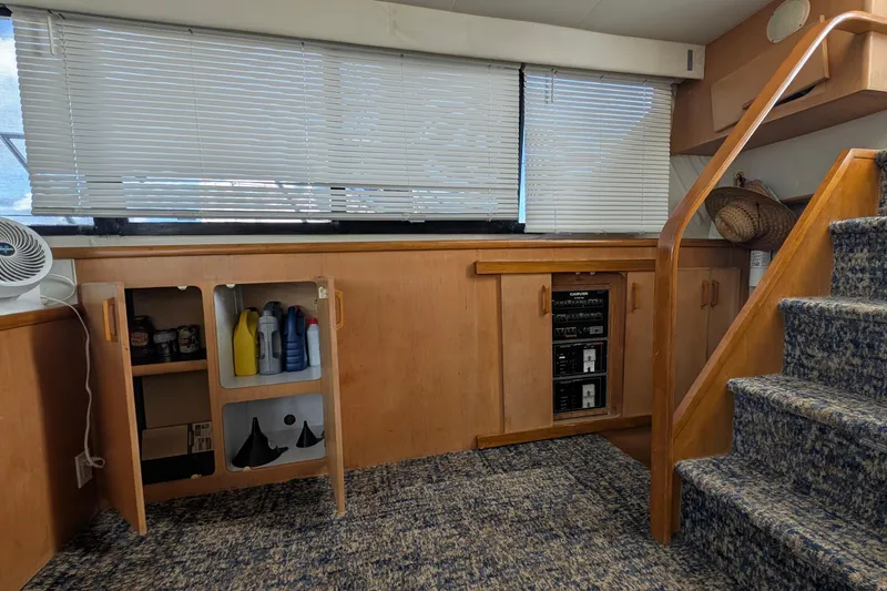 Slide: The Image of Interior of 1994 Carver 370 Aft Cabin Motor Yacht with wooden cabinetry and carpeted stairs. - 25