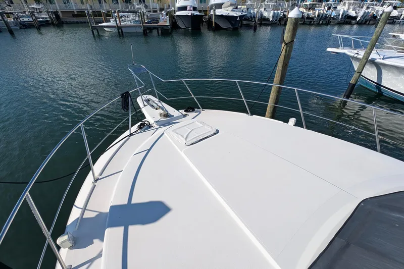 Slide: The Image of 1994 Carver 370 Aft Cabin Motor Yacht docked at marina, view from bow. - 3