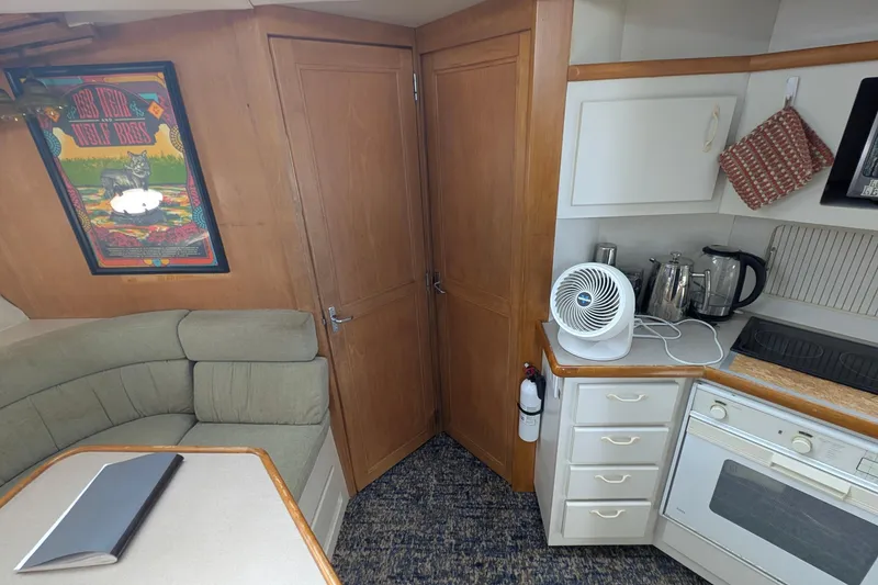 Slide: The Image of 1994 Carver 370 Aft Cabin Motor Yacht interior with kitchen and seating area. - 33