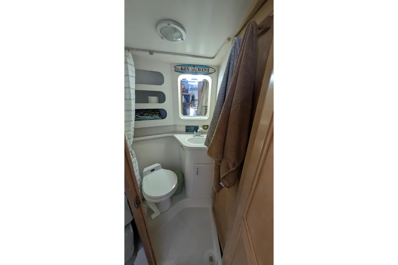 Slide: The Image of Bathroom interior of 1994 Carver 370 Aft Cabin Motor Yacht, featuring toilet and sink. - 38