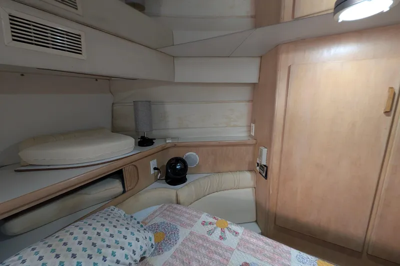 Slide: The Image of 1994 Carver 370 Aft Cabin Motor Yacht interior with cozy bed and wooden cabinetry. - 45