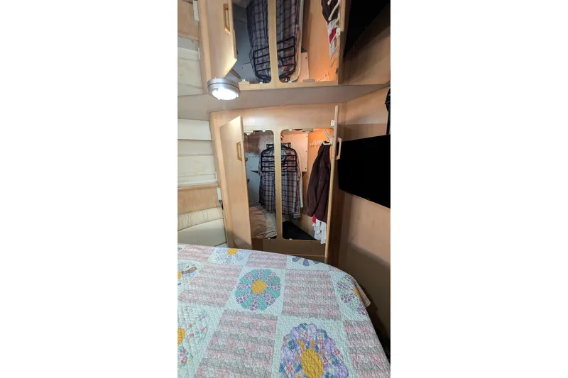 Slide: The Image of 1994 Carver 370 Aft Cabin Motor Yacht interior with cozy bedroom and closet space. - 46