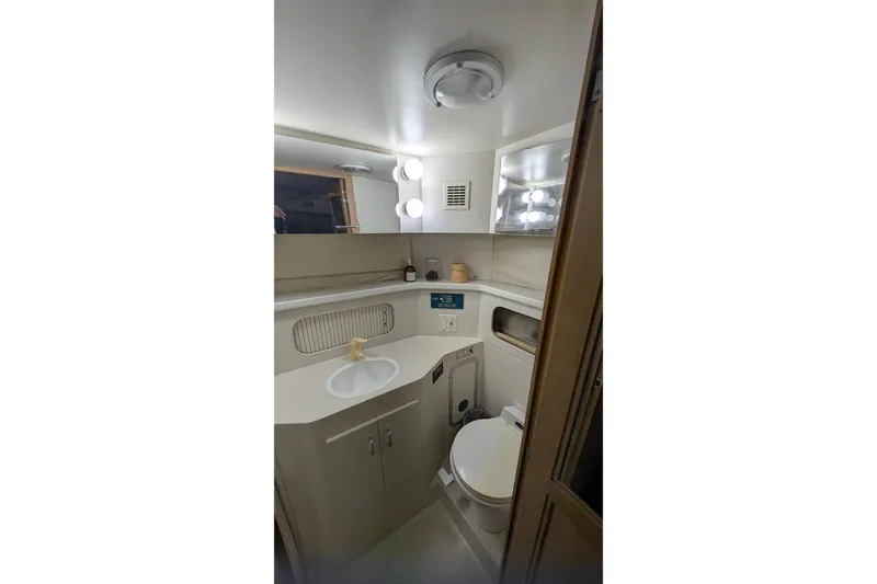 Slide: The Image of Bathroom interior of 1994 Carver 370 Aft Cabin Motor Yacht, featuring sink and toilet. - 47