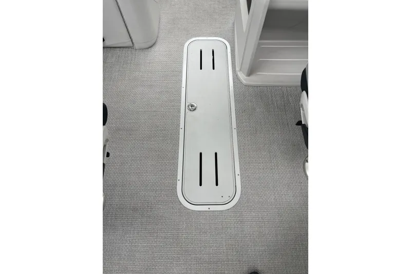 Slide: The Image of 2026 Tahoe 23 LTZ Quad Lounger boat interior with sleek floor compartment. - 7