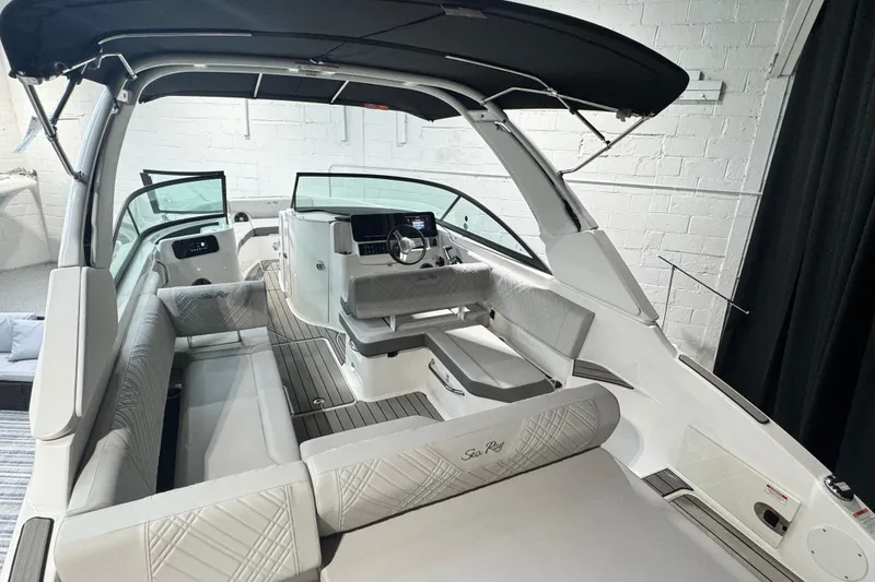 Slide: The Image of 2025 Sea Ray SDX 250 Outboard boat in showroom, featuring sleek design and Mercury engine. - 3
