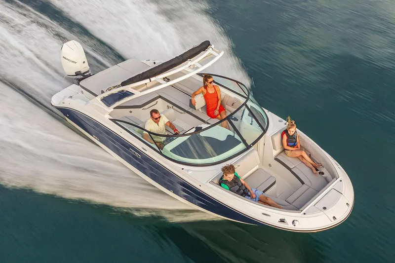 Slide: The Image of 2025 Sea Ray SDX 250 Outboard boat displayed indoors on stands. - 5