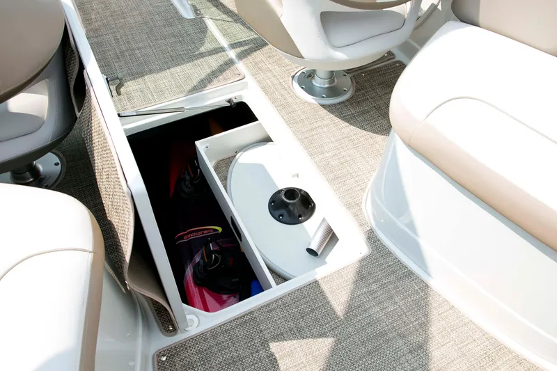 Slide: The Image of 2026 Crownline Eclipse E275 boat interior storage compartment with water sports equipment. - 12