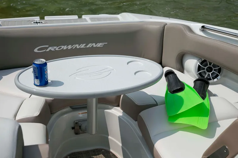 Slide: The Image of 2026 Crownline Eclipse E275 boat interior with table, drink, and flippers. - 15