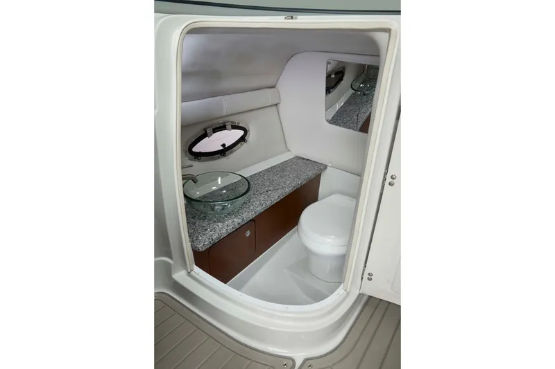 Slide: The Image of Interior of 2026 Crownline Eclipse E275 boat bathroom with modern fixtures and granite countertop. - 6