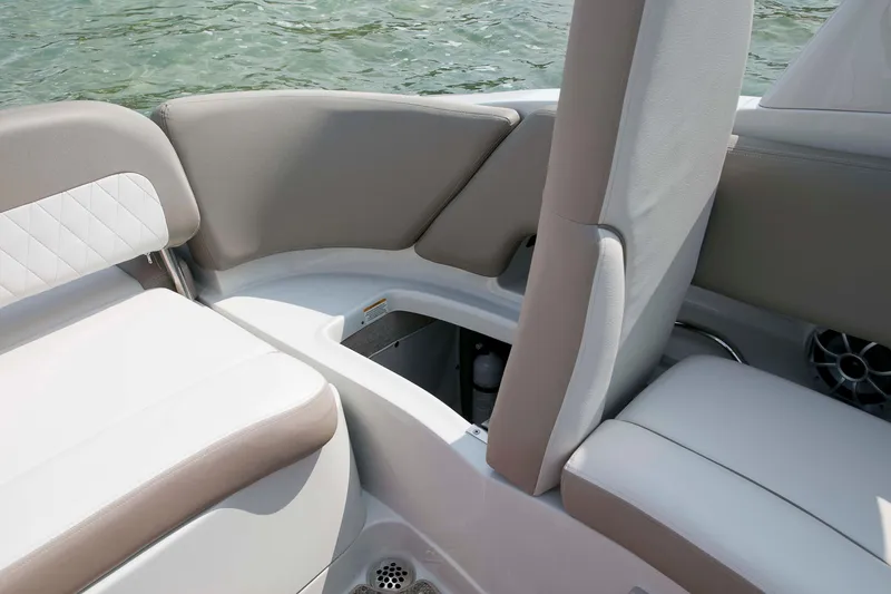 Slide: The Image of 2026 Crownline Eclipse E275 boat interior with beige and white seating, near water. - 8