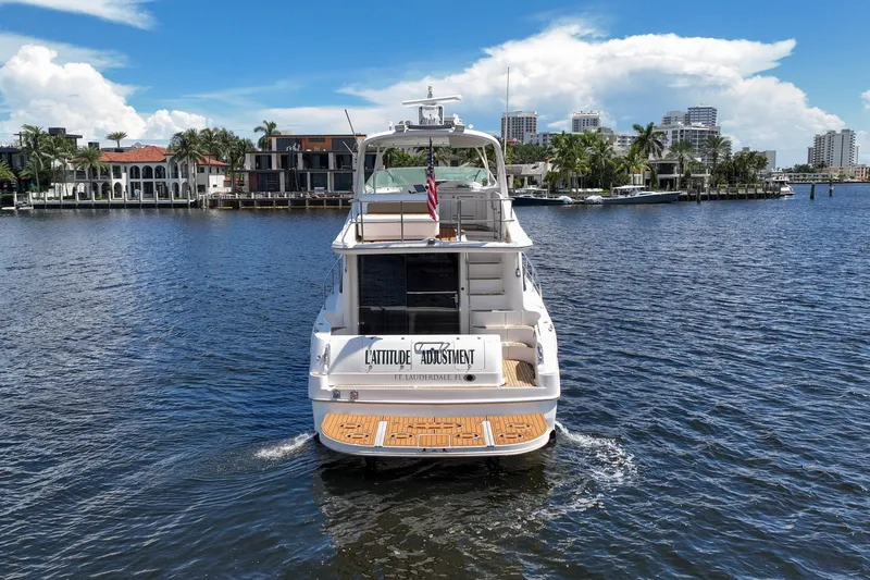 Slide: The Image of 2001 Sea Ray 540 Cockpit Motor Yacht cruising in a scenic waterfront setting. - 10