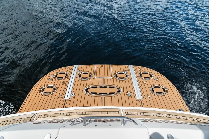 Slide: The Image of 2001 Sea Ray 540 Cockpit Motor Yacht deck overlooking calm blue water. - 12