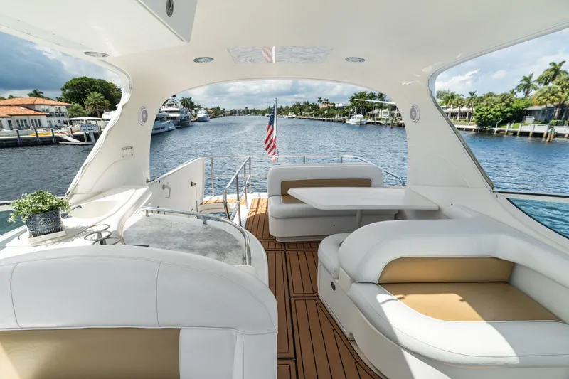 Slide: The Image of Luxurious 2001 Sea Ray 540 Cockpit Motor Yacht interior with elegant seating and scenic waterway view. - 15