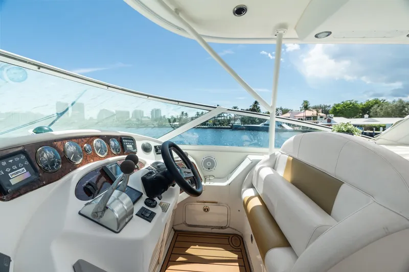 Slide: The Image of Cockpit view of 2001 Sea Ray 540 Motor Yacht, featuring steering wheel and control panel. - 17