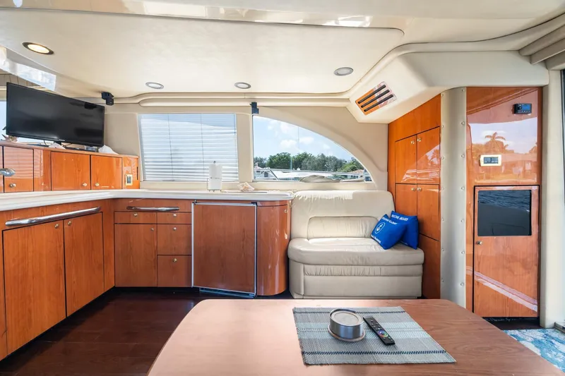 Slide: The Image of Luxurious interior of 2001 Sea Ray 540 Cockpit Motor Yacht with wood cabinetry and plush seating. - 24