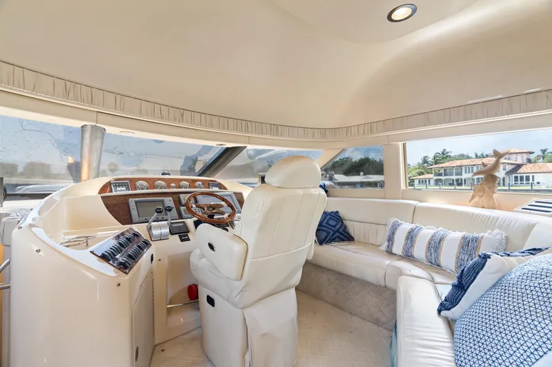 Slide: The Image of Luxurious interior of 2001 Sea Ray 540 Cockpit Motor Yacht with plush seating and helm. - 27