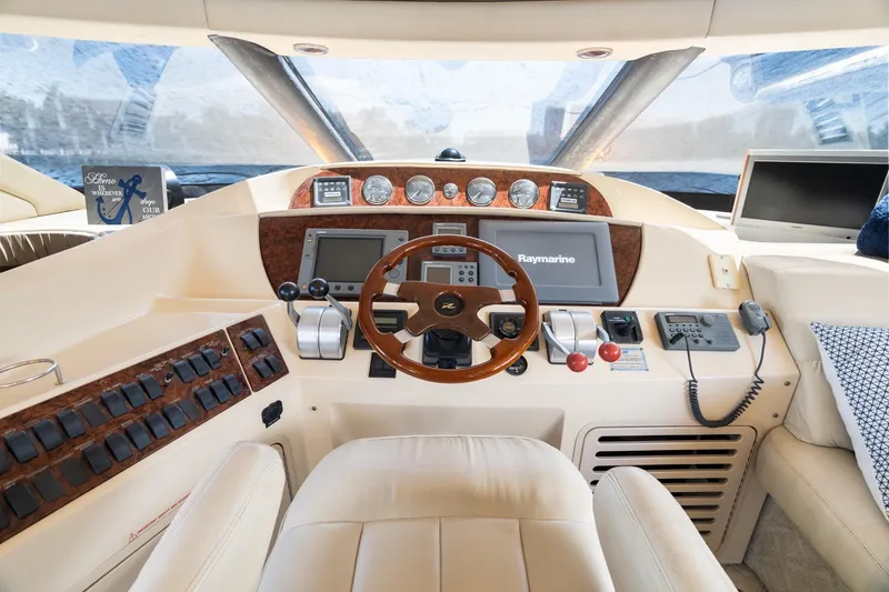 Slide: The Image of 2001 Sea Ray 540 Cockpit Motor Yacht helm with Raymarine navigation system and luxurious interior. - 29