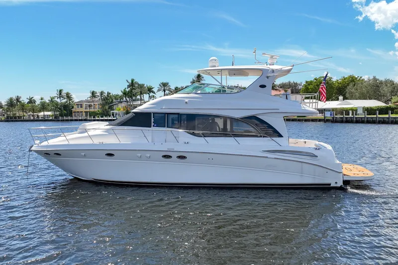 Slide: The Image of 2001 Sea Ray 540 Cockpit Motor Yacht on calm water, clear sky background. - 3
