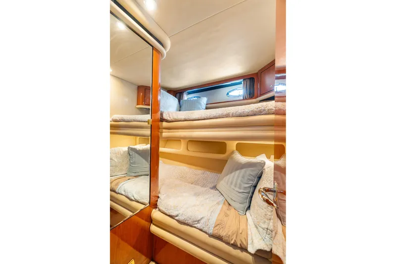 Slide: The Image of 2001 Sea Ray 540 Cockpit Motor Yacht interior with cozy bunk beds and elegant decor. - 33