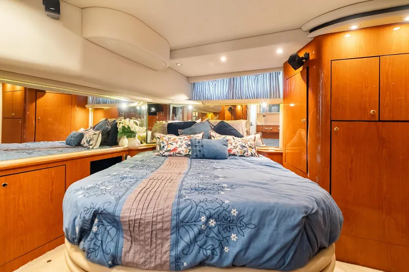 Slide: The Image of Luxurious bedroom interior of 2001 Sea Ray 540 Cockpit Motor Yacht with elegant wood cabinetry. - 35