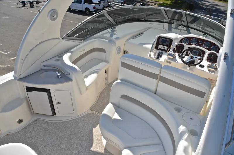 Slide: The Image of 2003 Sea Ray 320 Sundancer boat interior with helm, seating, and control panel. - 24