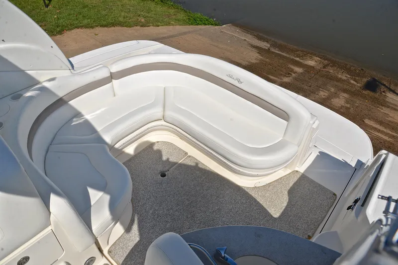 Slide: The Image of 2003 Sea Ray 320 Sundancer boat with white seating and carpeted deck. - 26