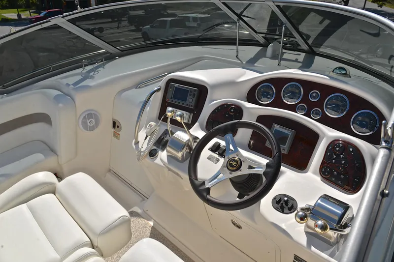 Slide: The Image of Cockpit of 2003 Sea Ray 320 Sundancer with steering wheel and control panel. - 28