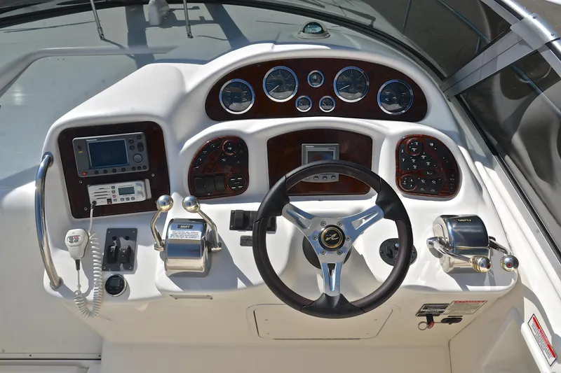 Slide: The Image of Cockpit of 2003 Sea Ray 320 Sundancer with steering wheel and control panel. - 32