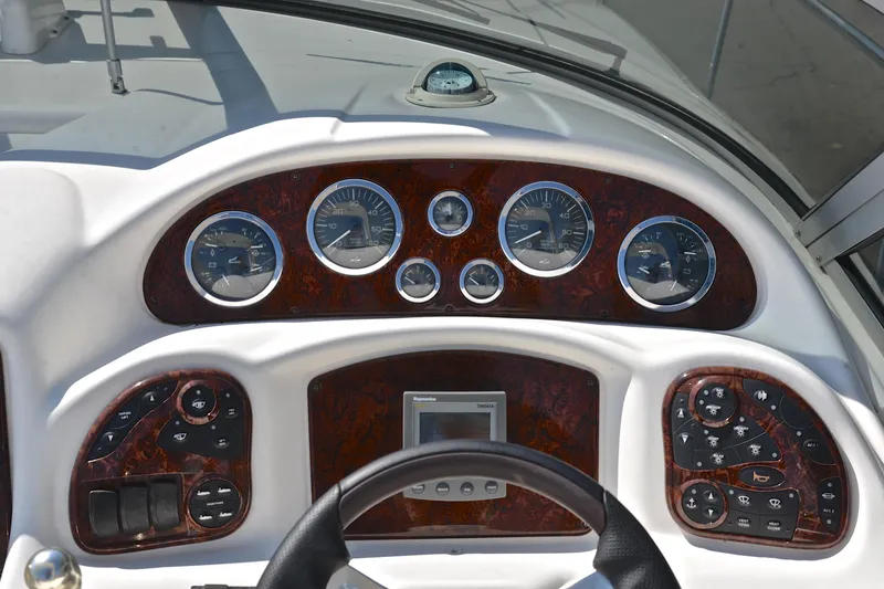 Slide: The Image of Dashboard of a 2003 Sea Ray 320 Sundancer boat with gauges and controls. - 34