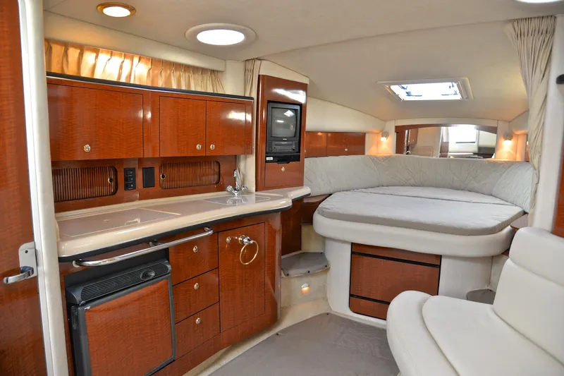 Slide: The Image of Luxurious interior of 2003 Sea Ray 320 Sundancer yacht with wood cabinetry and cozy seating. - 35
