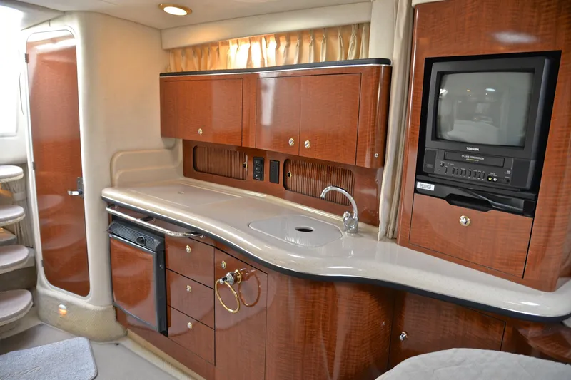 Slide: The Image of Luxurious interior of 2003 Sea Ray 320 Sundancer yacht with kitchenette and TV. - 38