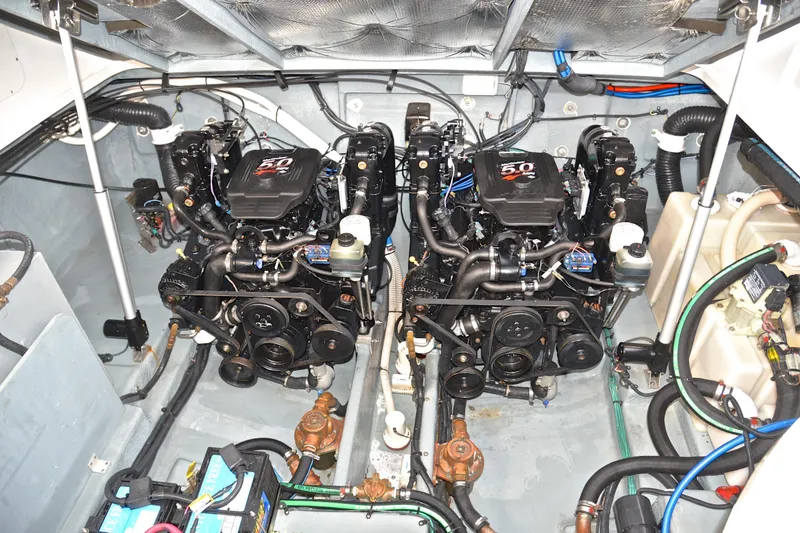 Slide: The Image of Engine room of 2003 Sea Ray 320 Sundancer with twin 5.0 engines and detailed components. - 44