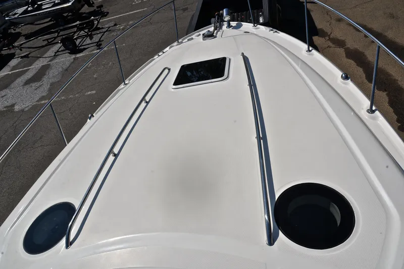 Slide: The Image of 2003 Sea Ray 320 Sundancer boat deck with railing and hatch. - 50