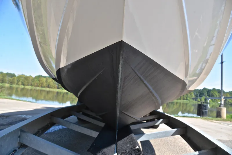 Slide: The Image of 2003 Sea Ray 320 Sundancer boat hull on trailer by a lake. - 54