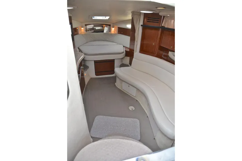 Slide: The Image of 2003 Sea Ray 320 Sundancer cabin interior with seating and bed. - 55