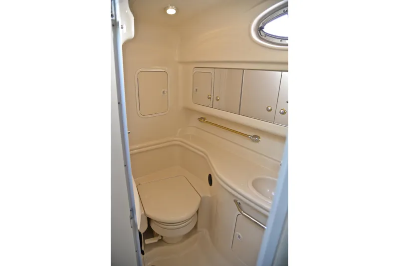 Slide: The Image of Bathroom interior of 2003 Sea Ray 320 Sundancer yacht, featuring compact design and storage. - 59
