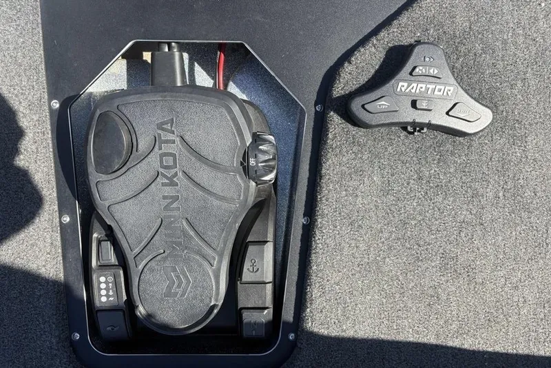 Slide: The Image of 2024 Skeeter ZXR20 boat foot pedal and control panel on carpeted floor. - 10