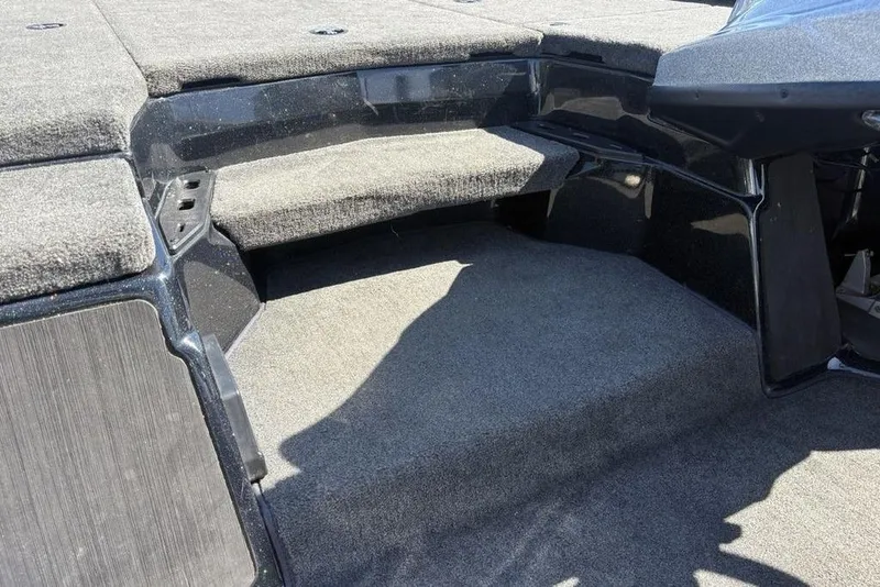 Slide: The Image of 2024 Skeeter ZXR20 boat interior with carpeted steps and storage compartments. - 12