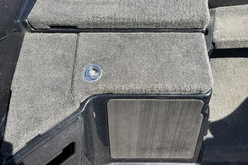 Slide: The Image of 2024 Skeeter ZXR20 boat deck with carpeted surface and storage compartment. - 13